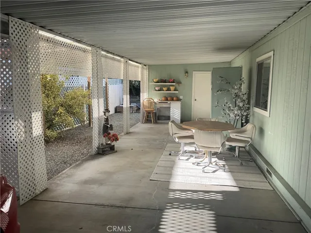Carport with little workshop behind that door.