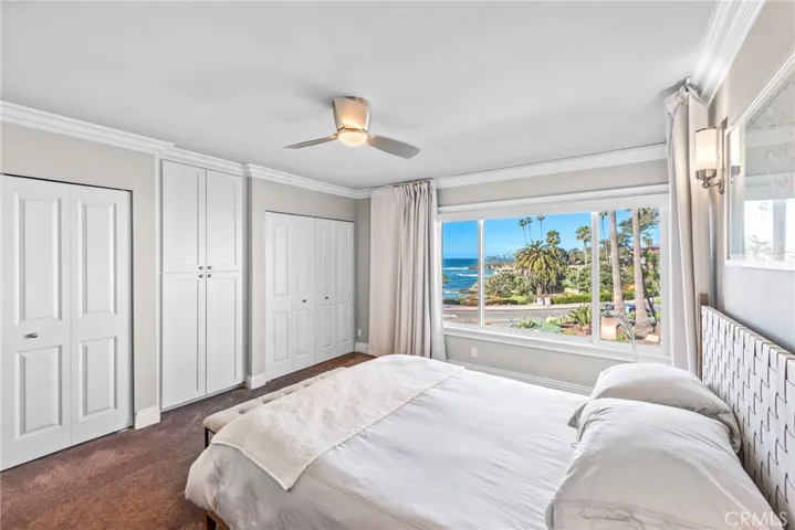 Primary bedroom with dual closets, blackout shades and ocean and whitewater views!