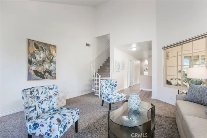 Living Room with 3 windows providing plenty of sunlight, high ceilings