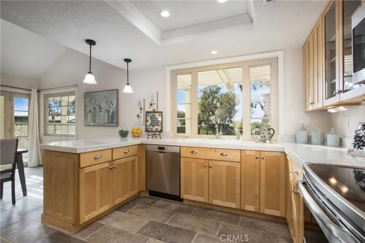 Remodeled kitchen with newer appliances and custom cabinets