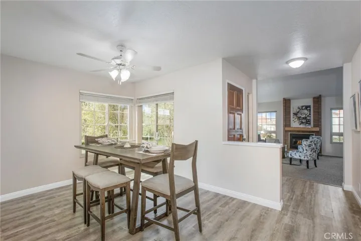 Formal dining area with green belt and side patio views