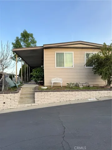 Front view with steps to front door on the left