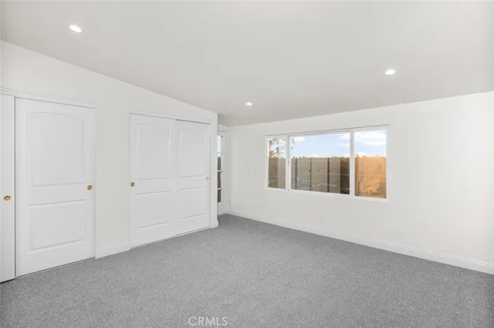 Primary bedroom with views and balcony.