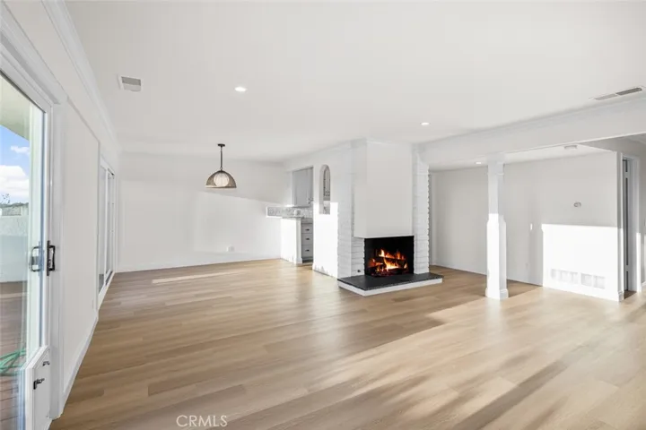 Living room and dining rooms with new vinyl plank flooring.