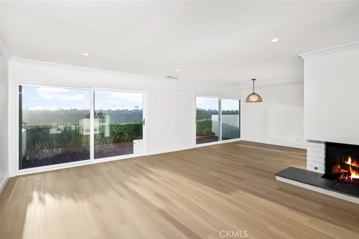 Dining and living rooms with cozy fireplace setting.