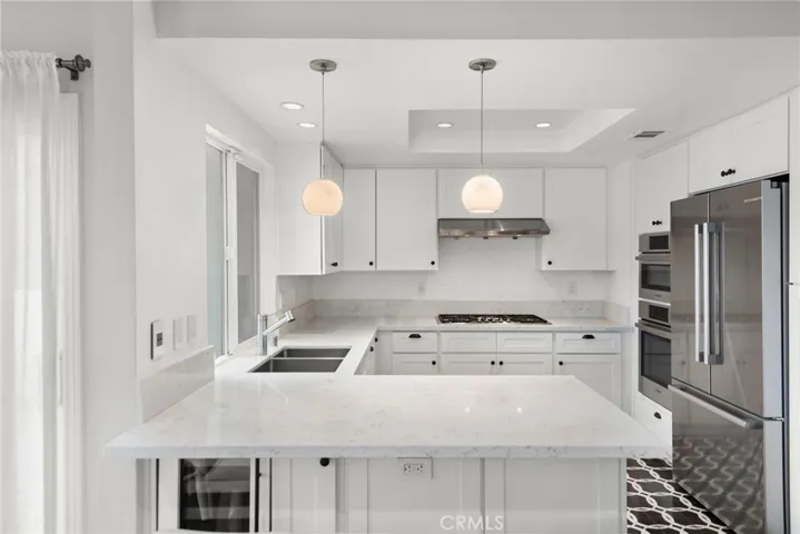 Light and bright chef's kitchen with designer tile floor