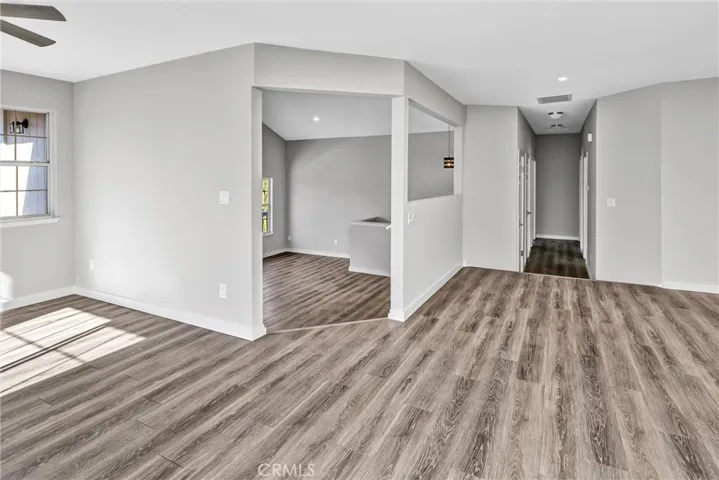 Looking out from the kitchen to the dining area and "sunken"/ split level living room; hallway to bedrooms and linen and coat closets.