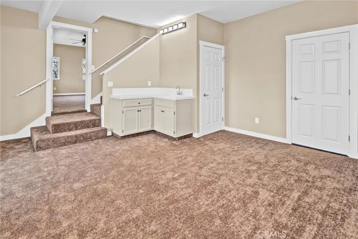 Family room/ rec room: one door to the WC, the other to under house storage.