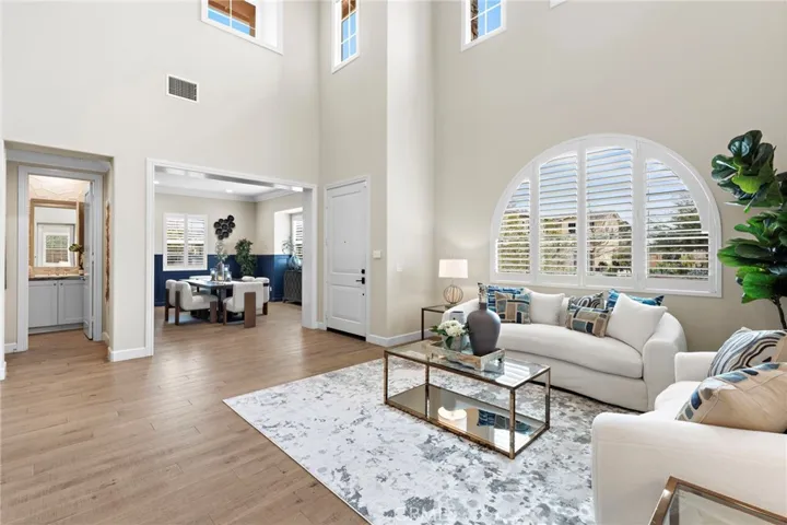 Open-concept floor plan boasts soaring ceilings & expansive windows that bathe the interior in natural light