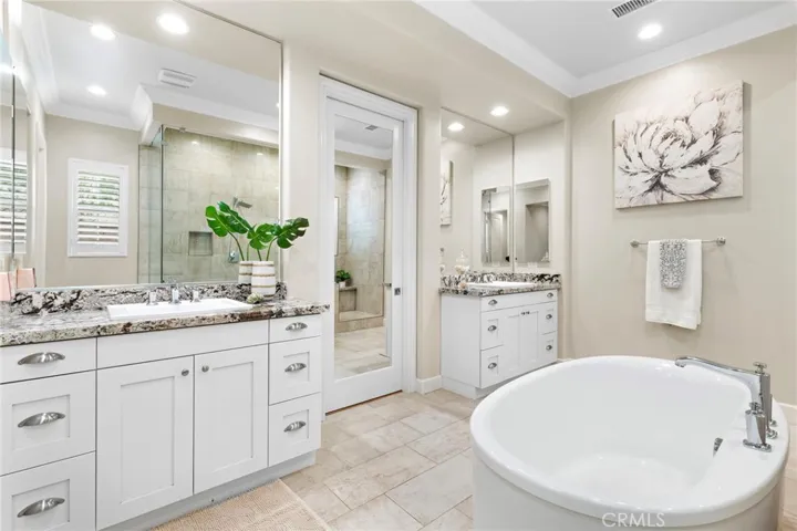 Master bathroom with his and her sinks and large soaking tub