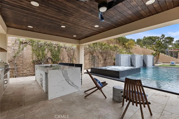 Outdoor kitchen over looking spa and pool