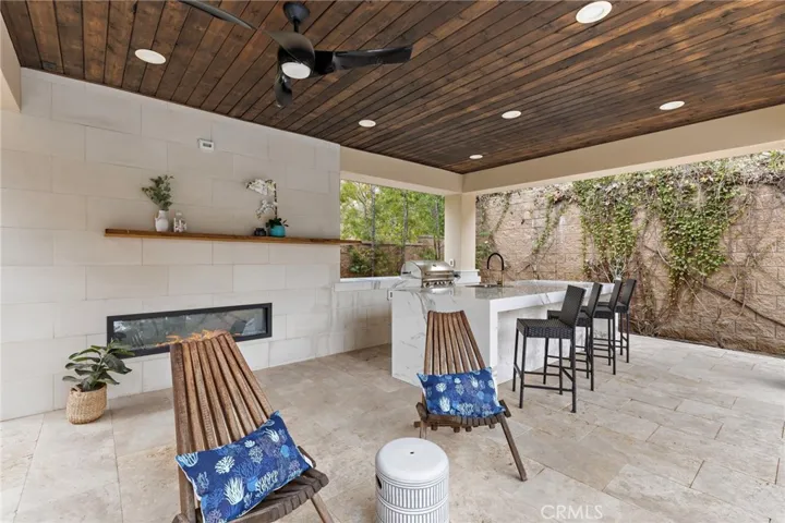 Cabana with built-in BBQ, granite gathering island & fireplace