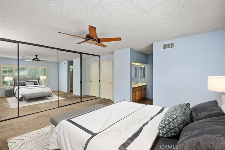 Spacious primary bedroom with wall length closet.
Note: This photo is virtually staged.