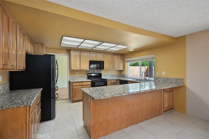 Large remodeled kitchen with granite countertops & plenty of cabinets with double oven & new refrigerator & microwave.  Kitchen has open floor plan with the spacious family room.