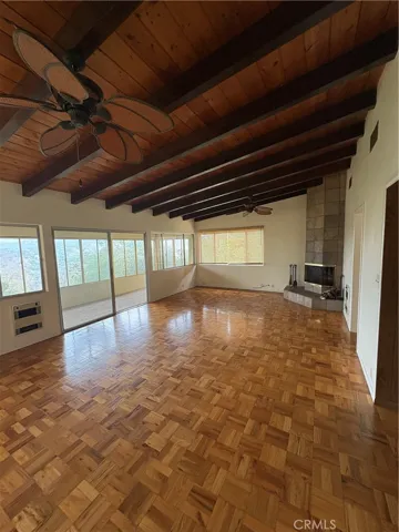 Main Floor Living Area with Beamed Ceiling, 2 Ceiling Fans and Parquet Hardwood Flooring