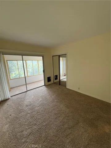 Lower Floor 2nd Bedroom with Direct Access to Enclosed Porch Area and Mirrored Wardrobe Closet