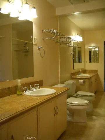 Lower Floor Full Bathroom with Granite Countertop and Travertine Tile Flooring