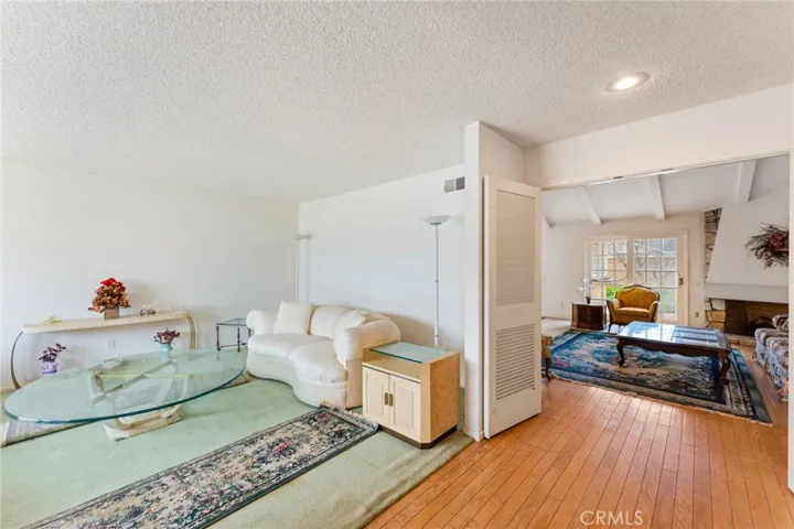 Entry with hardwood flooring that extends to the family and dining room