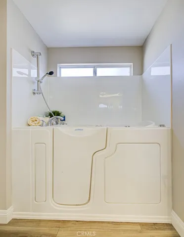 Walk-in tub/shower combo in right-side primary bathroom.