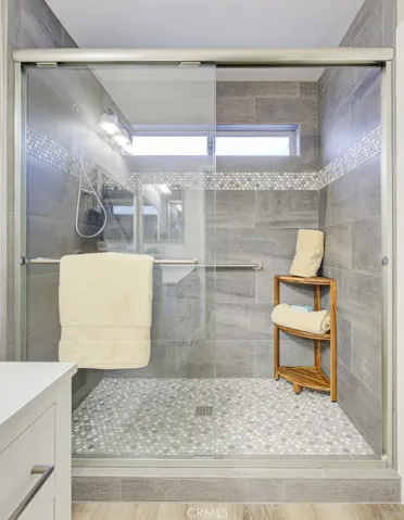 Walk-in shower in left-side primary bathroom.