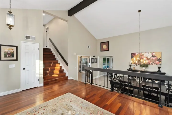 Large living room with high vaulted ceiling & lots of natural lighting.