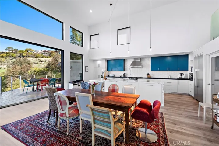  A custom oversized island anchors the kitchen, which hosts top-of-the-line Thermador appliances and a casual ocean-view breakfast space.