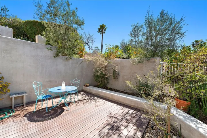 Features a sunny front-yard patio.