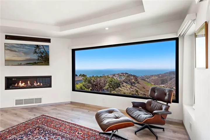 The top floor is reserved for the exclusive primary suite. Complete with its own ocean-view deck, the tranquil retreat presents a fireplace, walk-in closet, and an oversized shower.