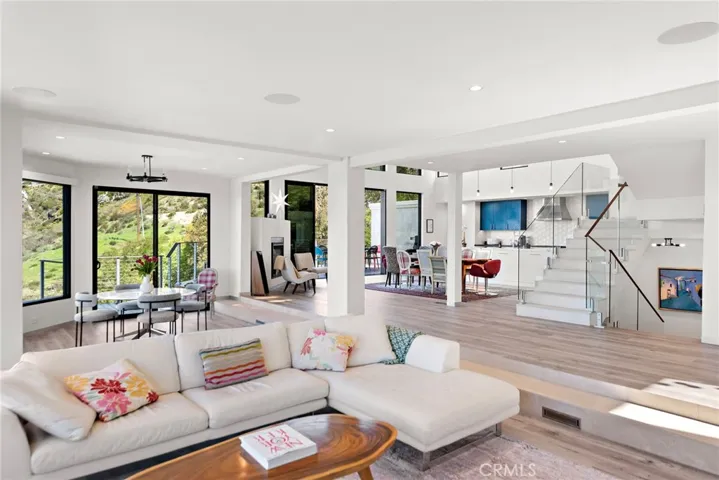 The main level showcases a wraparound view deck that connects to the lower-level pool. Approximately 4,427 square feet, the grand design is home to four ensuite bedrooms and four and 1/2 baths.