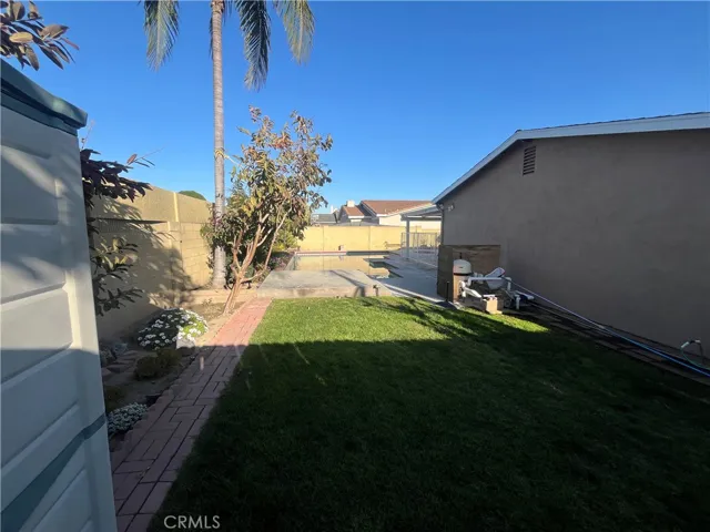 one of 2 grass areas in the backyard