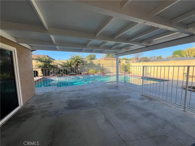 covered patio and rod iron fence for additional security