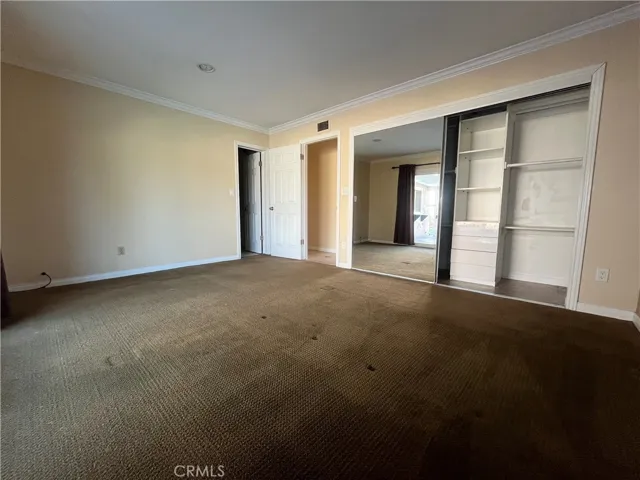 Primary suite has mirror closet doors with built-ins