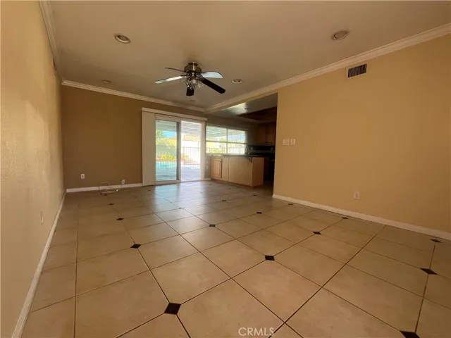 sliding glass door leads to covered patio in the backyard