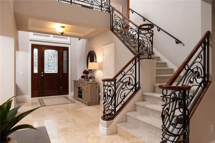 Foyer with grand staircase, recently polished and sealed traverine.