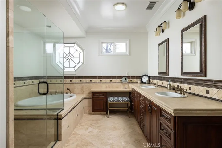 Primary en-suite bath with separate tub, shower, dual sinks and makeup vanity