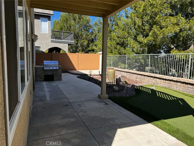 Low maintenance backyard with built-in BBQ and artificial grass