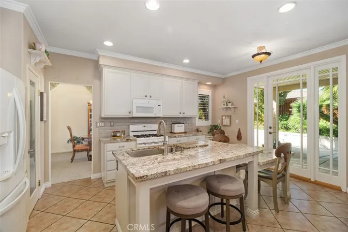 The Kitchen has Direct Access to the Outdoor Patios.