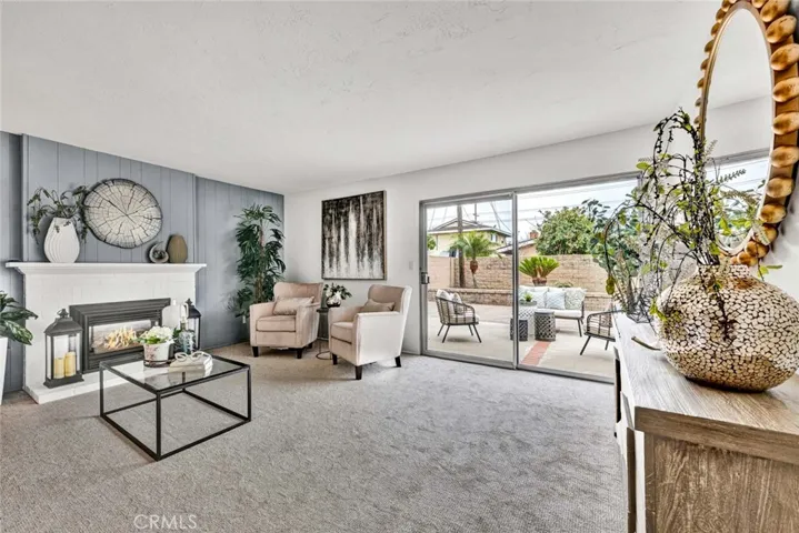 Beautiful Living Room with New Designer Carpet, New Electric Fireplace with Mantel and White Brick Surround. Large Slider that Opens to Huge Private Backyard.