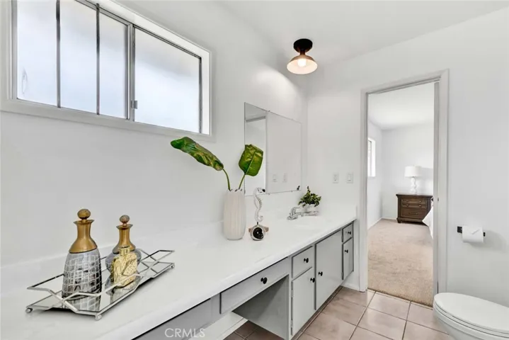 Jack & Jill Bathroom with Resurfaced Countertop, Sit-Down Vanity and Tiled Shower