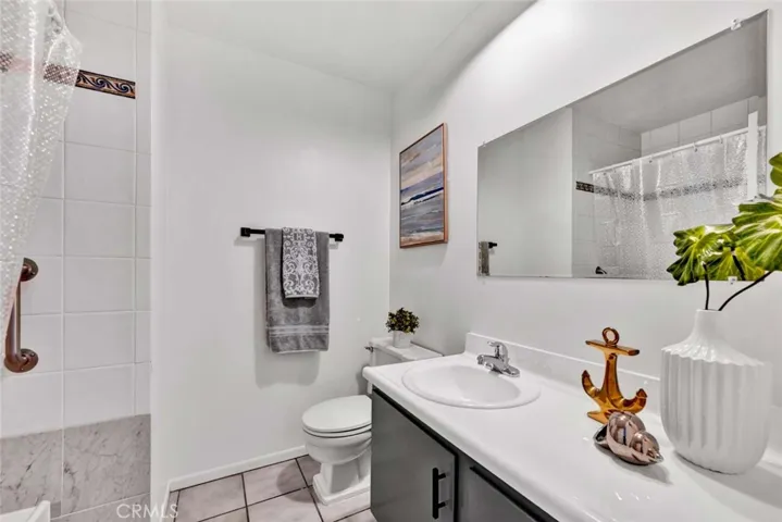 Hallway Bathroom Upgraded with Designer Tile Surround Around Tub/Shower Combo