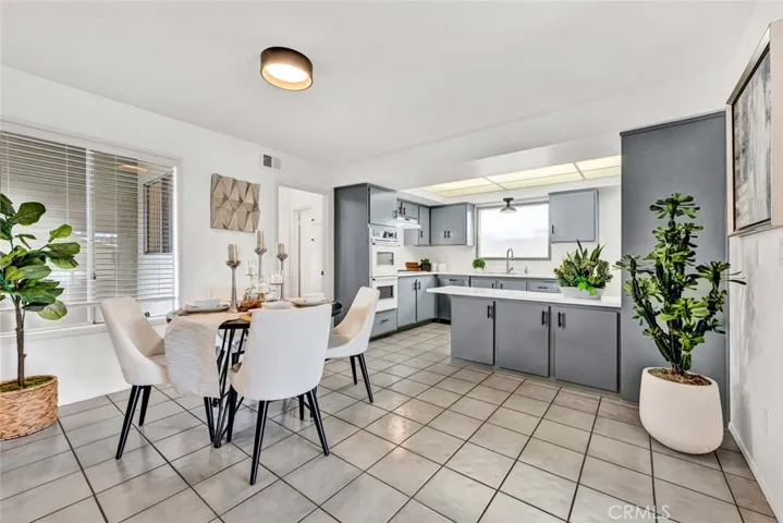 Spacious Dining Room is Open to Sunlit Kitchen
