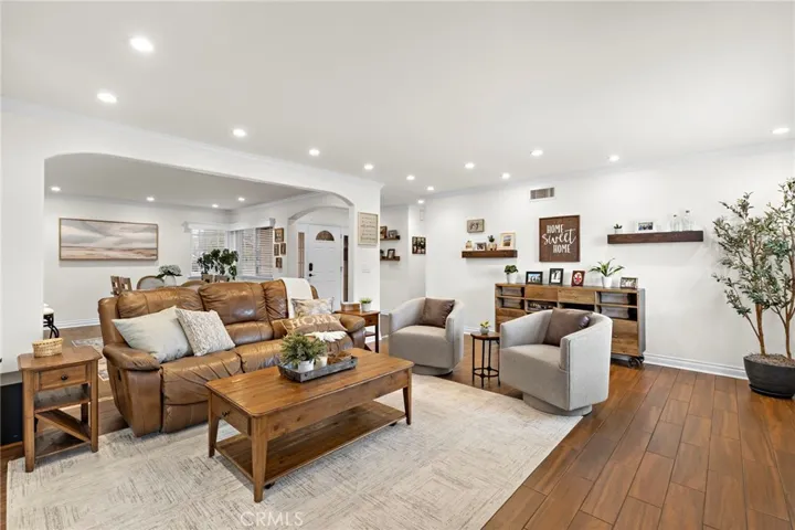 Living room with recessed light and crown molding throughout the home