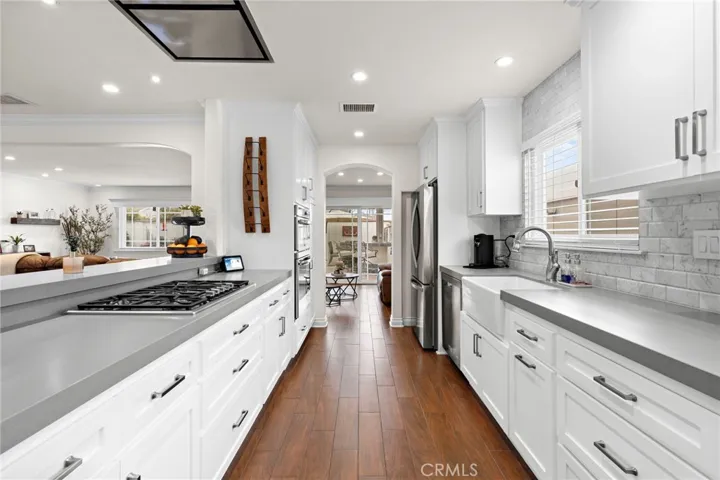 Hhigh-end stainless steel appliances—including a Thermador gas cooktop, Zephyr disappearing range hood w/ remote, gas oven, micro/convection oven, KitchenAid dishwasher