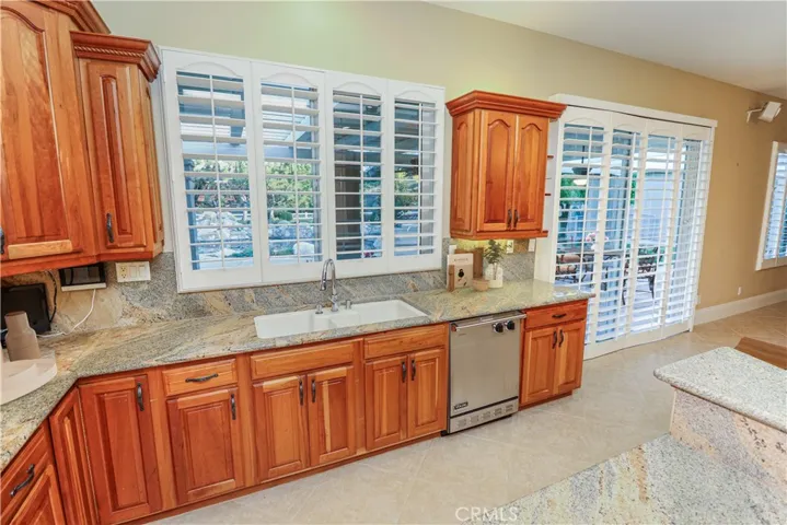 Kitchen looks out onto the backyard pool area.