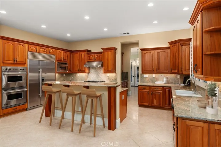 Chef's kitchen w/ island, warming drawer and sink.