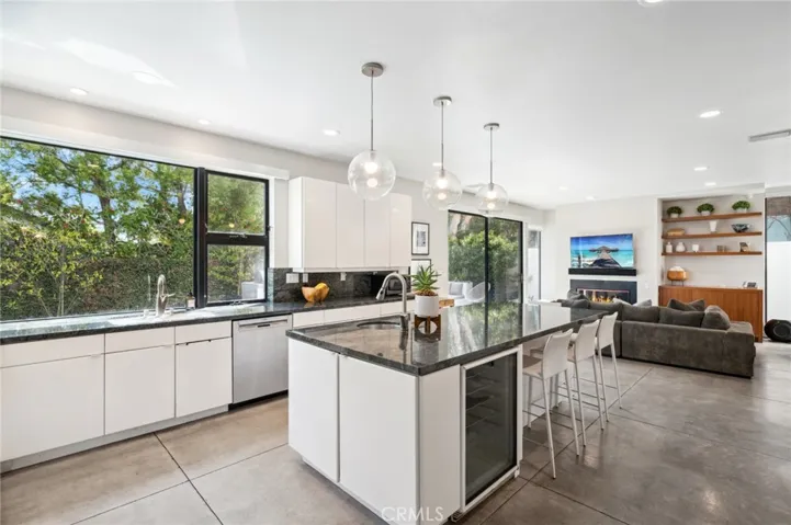 The gourmet kitchen is a chef’s dream, featuring a spacious center island, stone countertops, and a generous walk-in pantry.