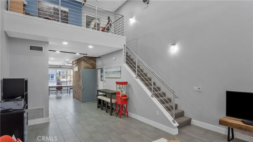 From the living room stairs to off area and primary bedroom and bathroom.