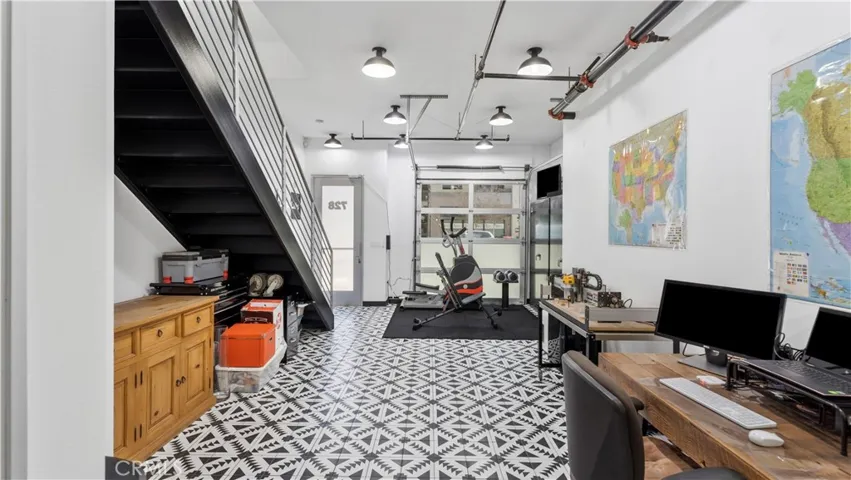 Custom tile floor, industrial garage front door and direct access front door to the street.