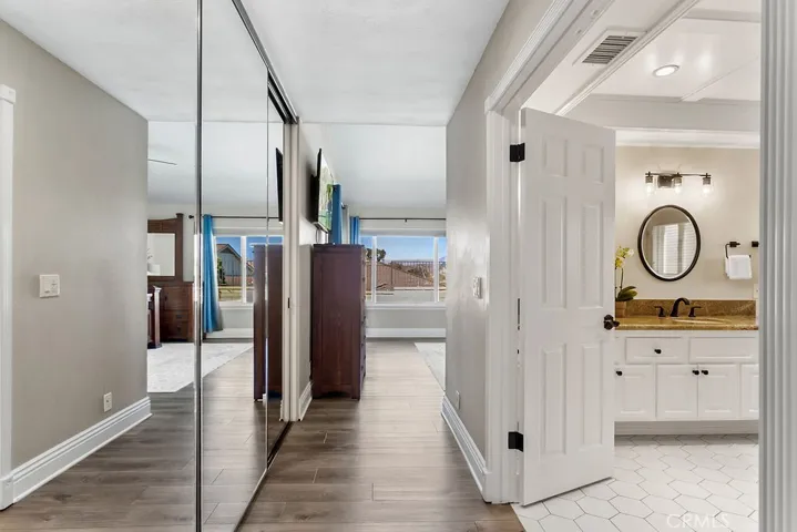 Mirrored closets and grand dual door bathroom entry