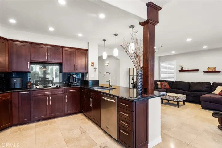 Slab granite counters and rich wood cabinetry all replaced and great organization features inside the cabinets.
